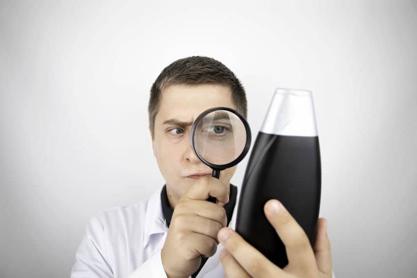 Laboratory Technician examines a sample of shampoo