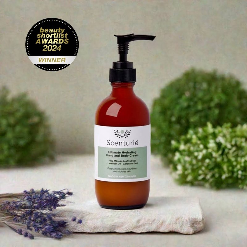 Scenturie's award-winning Ultimate Hydrating Hand and Body Cream in its 185ml amber glass bottle, styled in a minimalist bathroom. Winner of "Best Hand & Body Cream" at Beauty Shortlist Awards.