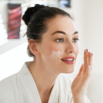 woman applying day cream
